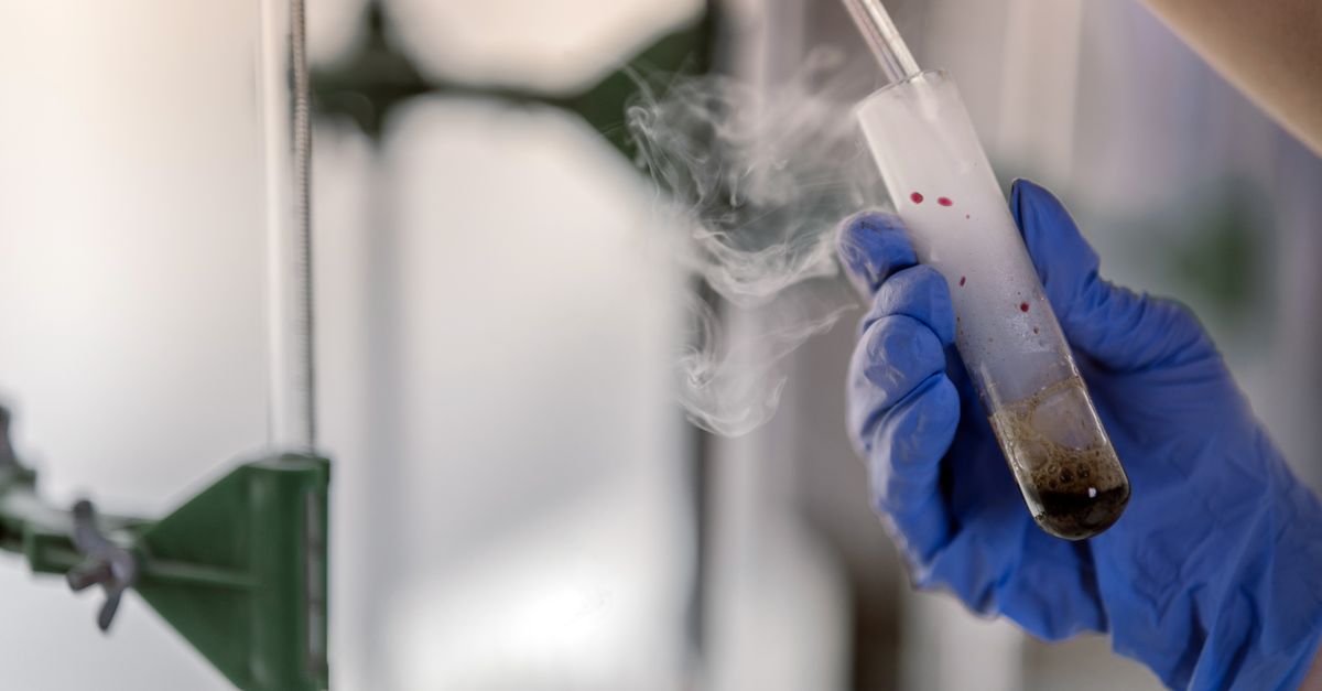 Gloved hand holding a frosted vial in cold vapour, where embryos wait before a frozen transfer