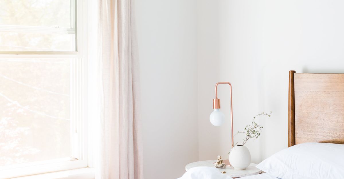 Quiet bedroom in morning light, where two week wait cramps are usually noticed most at night
