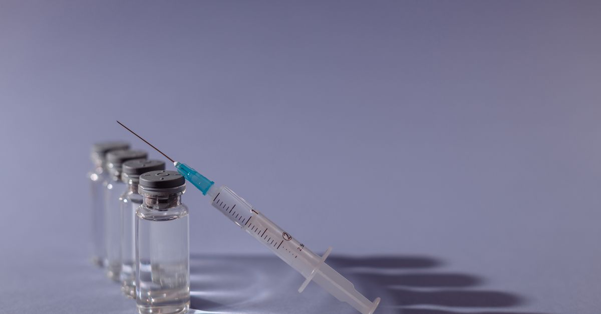 A syringe beside small glass vials, the single hCG trigger injection a modified natural FET cycle uses
